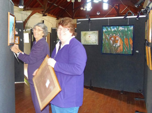 Members of the St Marks Warwick community help hang some of the artworks during last year’s Art @ St Mark’s.